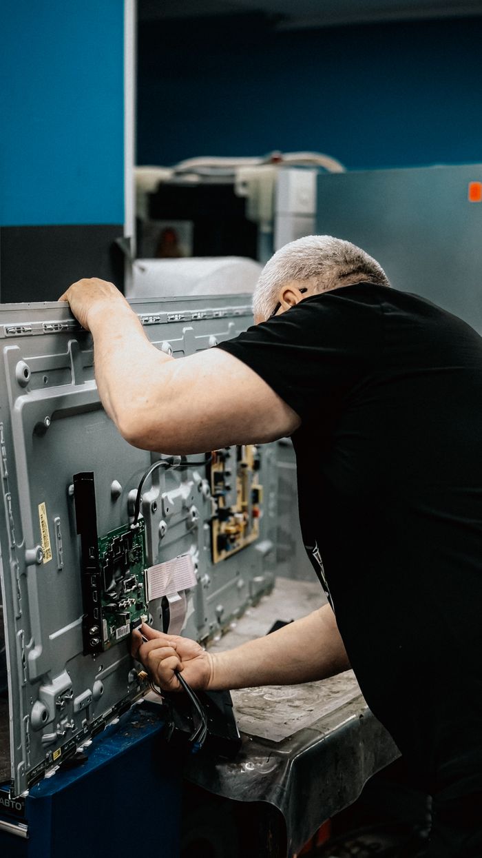 Technician repairing a TV